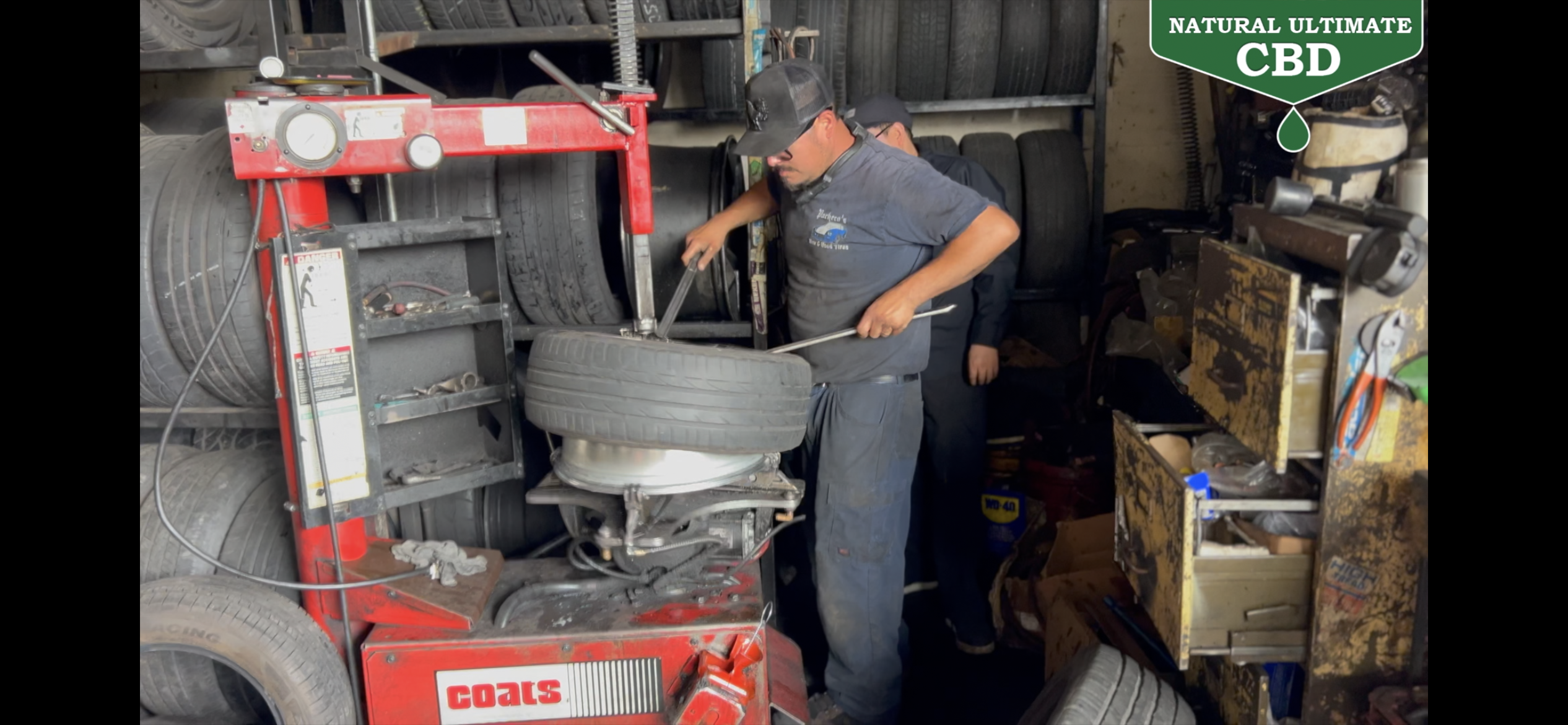 Technician operating a tire mounting machine at Pacheco's Tire Services in Compton California