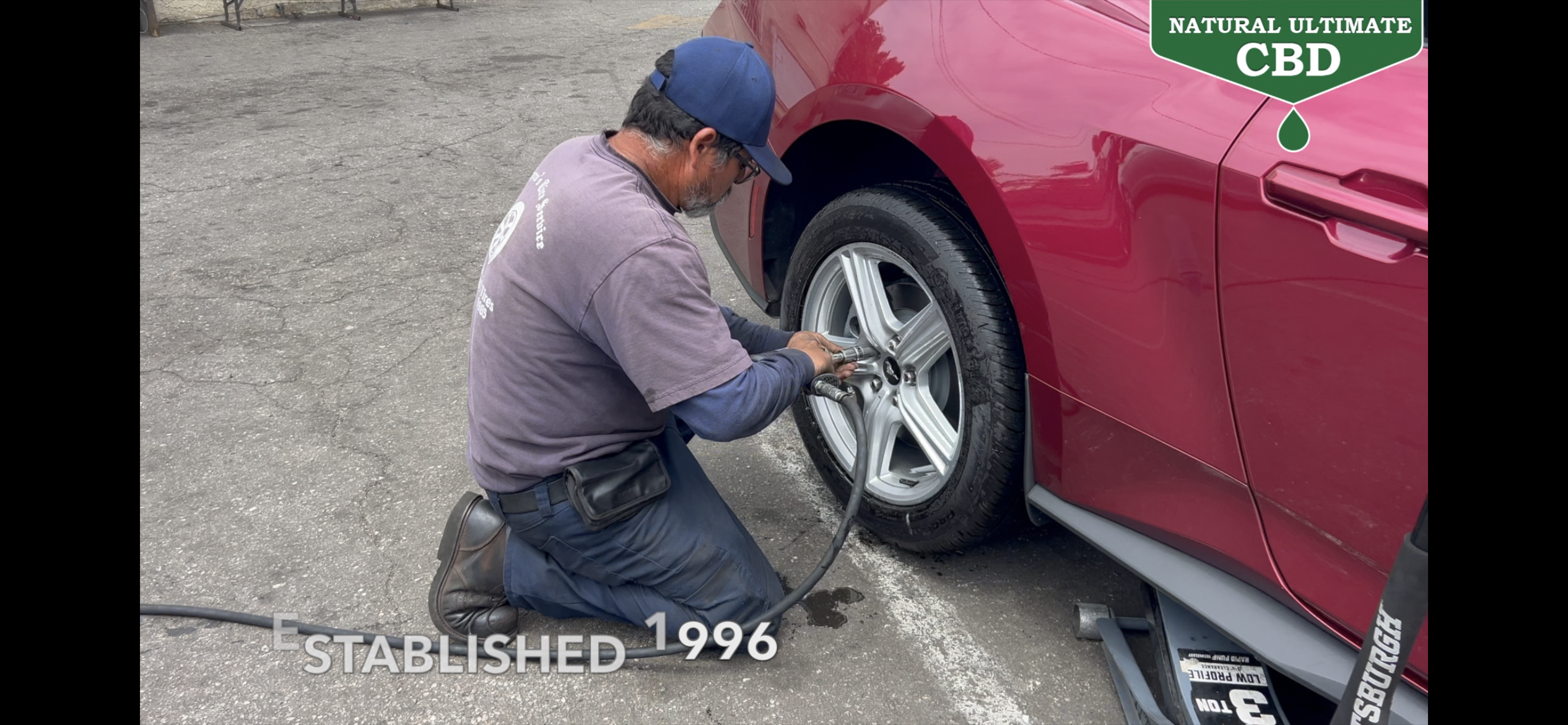 Technician servicing a vehicle tire at Pacheco's Tire Services in Compton California